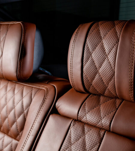 A luxury car interior in brown and black colors