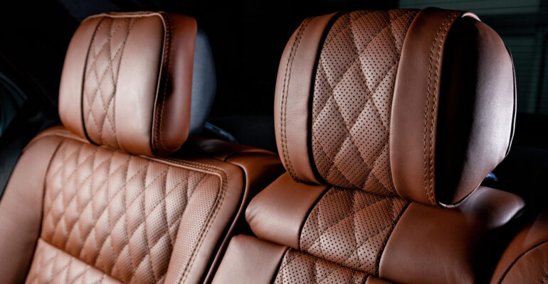 A luxury car interior in brown and black colors
